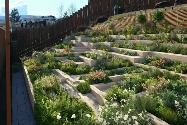 Not sure what to do with your sloped backyard? Try our AI-designed contemporary gardens, featuring raised flower beds and terracing for both aesthetics and functionality. Never run out of ideas for your sloped backyard.