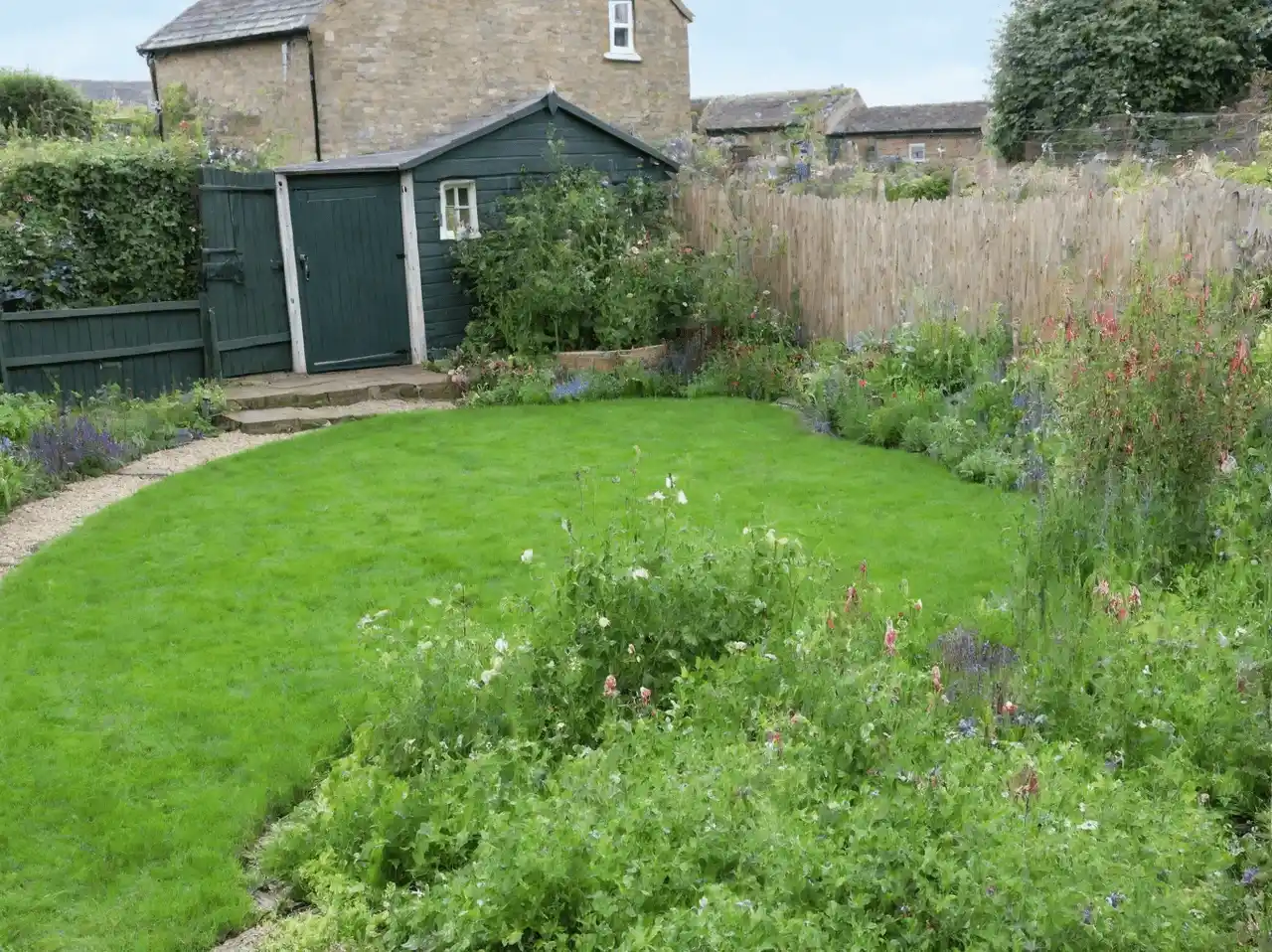 A rustic and charming overgrown garden creates a magical atmopsphere of exploration and oneness with nature, one of the many back garden ideas generated with Rescape AI.